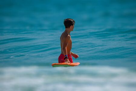 Daytona Beach Florida. September 09, 2019 Girl with surfboard enjoying waves at Main Street Pier area 4のeditorial素材