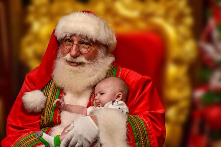 Orlando, Florida. December 19, 2018. Funny Santa and sweet baby at Seaworld in International Drive area.のeditorial素材
