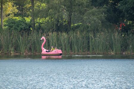 Orlando, Florida. October 24, 2019. Mother and daughter enjoying swan boat ride at Seaworldのeditorial素材