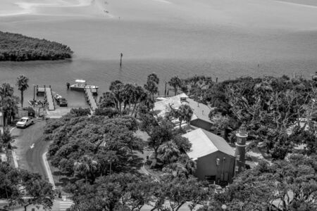 Ponce de Leon Inlet, Florida. July 19, 2019 Panoramic view Bar and Grill with small lighthouse on Halifax river coast, from lighthouseのeditorial素材