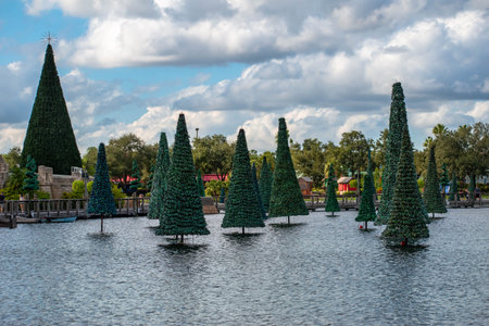 Orlando, Florida. November 06, 2019. Christmas trees on lake on lightblue cloudy sky background at...