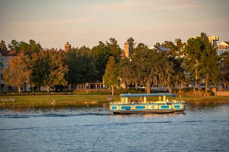 Orlando, Florida. November 29, 2019 Taxi boat sailing at blue lake in Lake Buena Vista 1のeditorial素材
