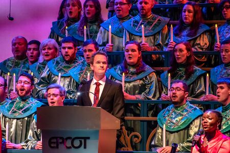 Orlando, Florida. December 03, 2019. Neil Patrick Harris telling the touching story of Christmas, accompanied by orchestra and heavenly choir in Candlelight Narrators at Epcot 31のeditorial素材