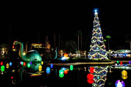 Orlando, Florida. November 27, 2019. Big dinosaur, Christmas tree and holidays decorations in Echo Lake at Hollywood Studios (5)のeditorial素材