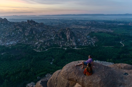 HAMPI KARNATAKA INDIA - FEBRUARY 02 2016: People waiting for sunrise at the top of viewpoint of Hampiのeditorial素材