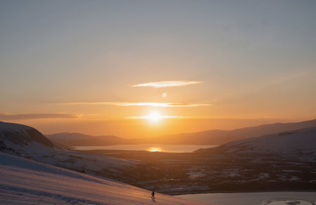 Beautiful sunset in the mountains. Winter landscape with snow and sunの素材