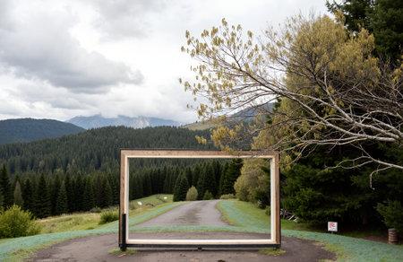 Photo frame in the middle of the road in the mountains. Beautiful landscapeの素材