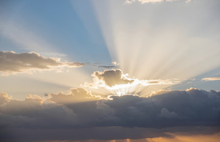 Sunset sky with clouds and sunbeams. Nature background.の素材