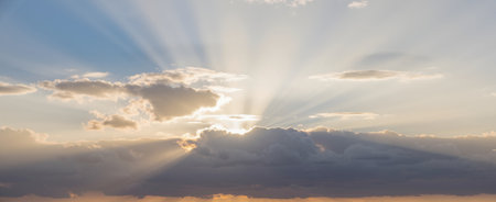 Sunset sky with clouds and sun rays. Panoramic viewの素材