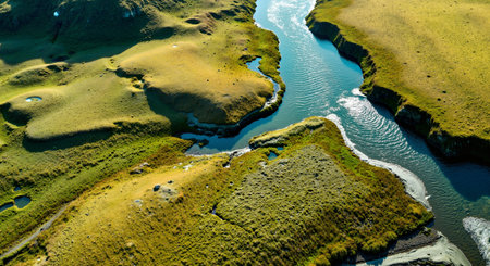 Aerial view of a river flowing through the grassland in Icelandの素材