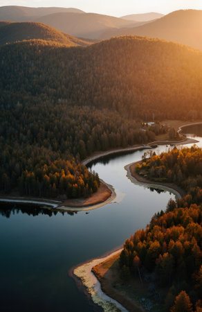Aerial view of beautiful mountain lake in autumn forest at sunset.の素材