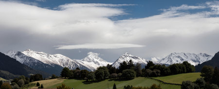 panoramic view of the alps with clouds in the skyの素材