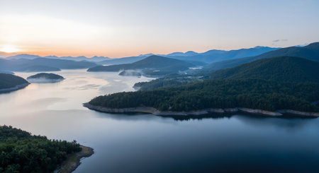 aerial view of misty lake in the mountains at sunrise timeの素材