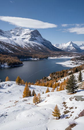 Beautiful winter landscape with lake and snow-capped mountains.の素材
