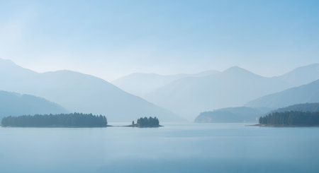 Panorama of the lake and mountains in the fog. Beautiful landscape.の素材