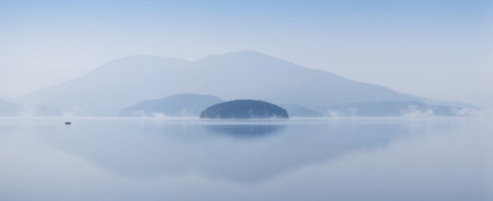Panoramic view of a foggy lake in the mountains.の素材
