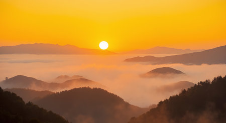 Beautiful sunrise in the mountains with fog and sun on the skyの素材