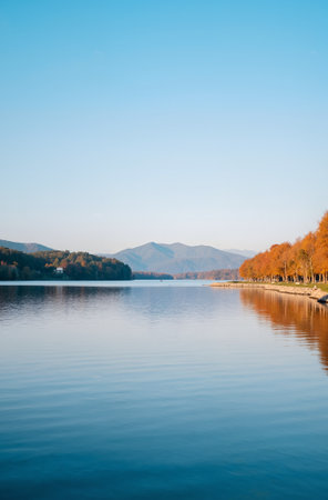 Autumn landscape with lake and mountains in the background. Beautiful autumn landscape.の素材