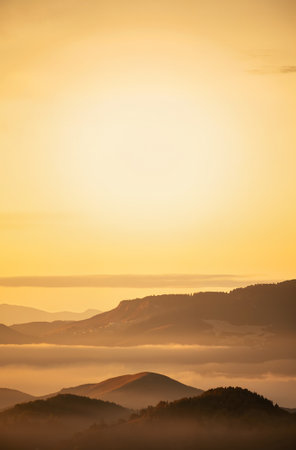 Sunrise over the mountains in the fog. Beautiful mountain landscape.の素材