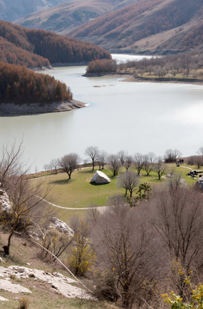 Landscape view of a lake with a tent in the mountains.の素材