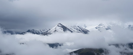 Panoramic view of the snow capped mountains in the clouds.の素材