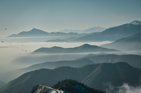 Beautiful view of the mountains with clouds and birds in the morningの素材