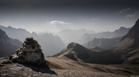Mountain landscape with stones in the foreground and dramatic clouds in the backgroundの素材