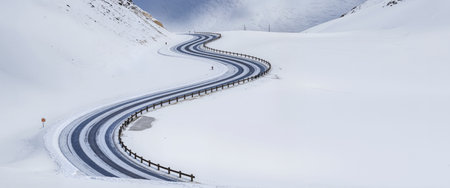 Winding road in the snowy mountains, panoramic view.の素材