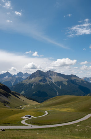 Mountain landscape with a road in the foreground and mountains in the backgroundの素材