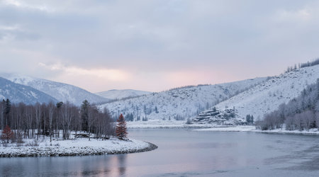 Beautiful winter landscape with snow covered trees and lake in the mountainsの素材