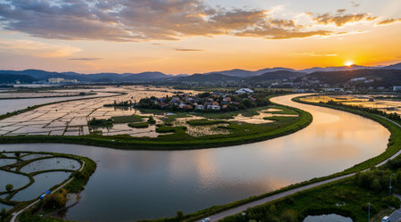 Aerial view of a small village on the banks of the Danube at sunsetの素材