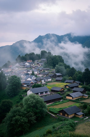 Village in the mountains at the foot of the clouds. View from above.の素材