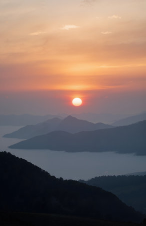 Beautiful sunrise over the sea in the mountains. The sun goes down over the mountains.の素材