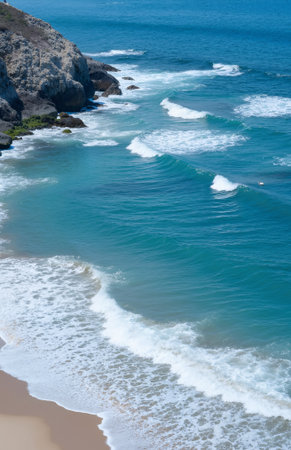Aerial view of a beautiful beach with waves breaking on the shoreの素材