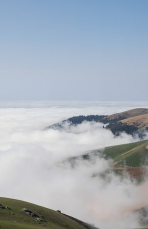 clouds and fog in the mountains at autumn, beautiful nature backgroundの素材