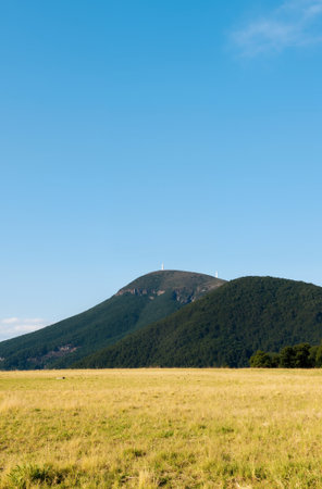 Mountain landscape with green meadow and blue sky on sunny dayの素材