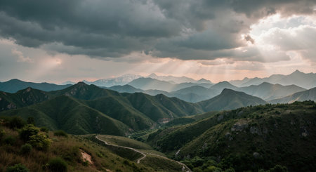Mountain landscape with sunbeams and clouds at sunset, Chinaの素材