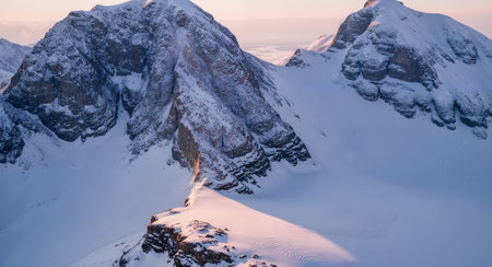 Aerial view of the snow-capped mountains at sunset.の素材