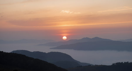 Beautiful sunset on the mountain in the fog. Landscape.の素材