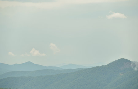 Beautiful landscape view of mountains and blue sky with white clouds.の素材
