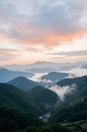 Mountain landscape with fog in the morning at sunrise. View from the top of the mountain.の素材