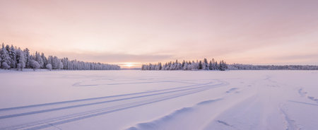 Panoramic view of the frozen lake covered with snow at sunset.の素材