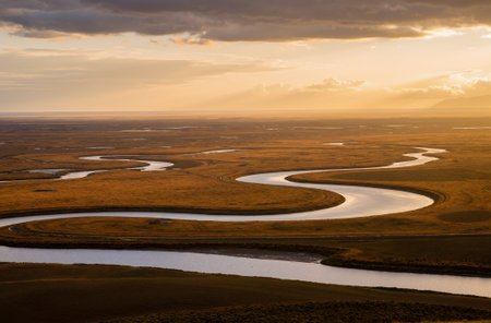 Landscape view of grassland and river at sunset, Iceland.の素材