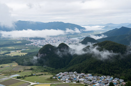 Landscape view of the mountains and the village in the fog.の素材