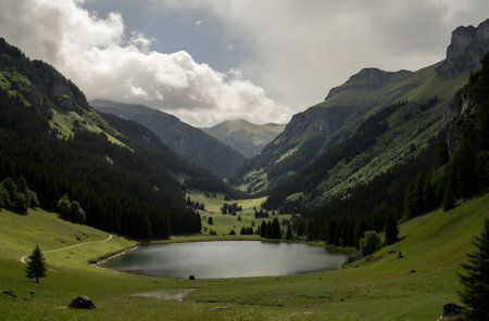 Mountain landscape with lake and cloudy sky in summer, Switzerland.の素材