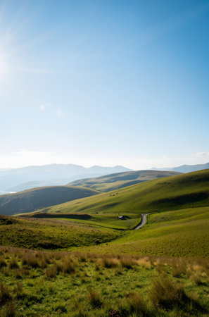 Landscape of green hills and blue sky with clouds in the backgroundの素材