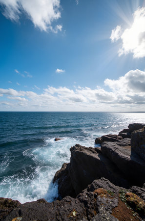 Rocks in the sea on a background of blue sky with cloudsの素材