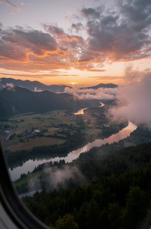 View from the window of a plane on a mountain lake at sunsetの素材