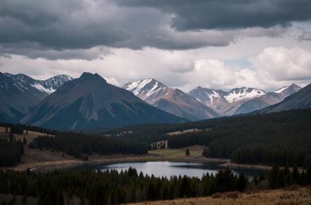 Mountain landscape with lake and forest under cloudy sky, Kyrgyzstanの素材