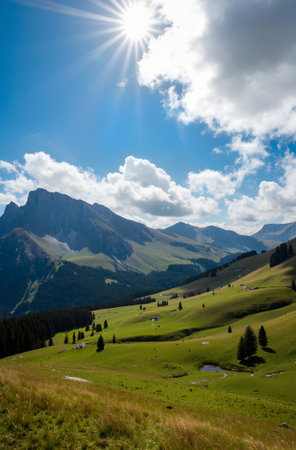 Beautiful alpine landscape with green meadows and mountains under blue skyの素材